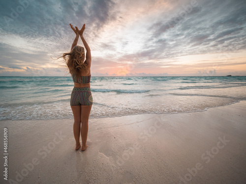 Yoga pose on the beach Maldives photo