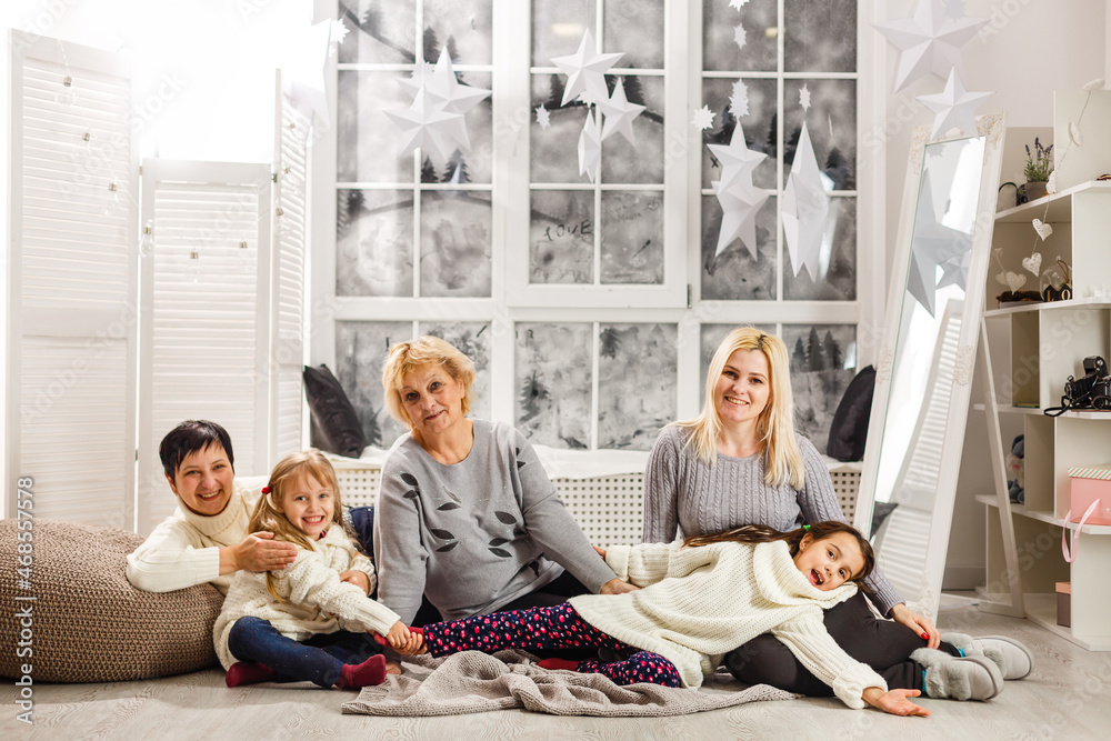 Fototapeta premium happy young family holding christmas gift and smiling