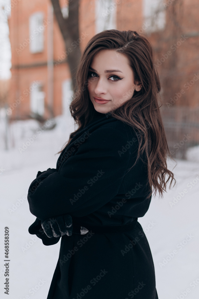 beautiful girl, dark hair, winter, walking around the city, black coat