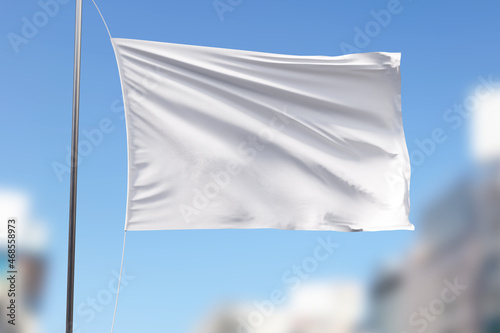 White flag mockup on the blue sky background.
