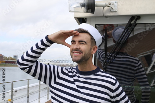 Sailor looking at the horizon in deck
