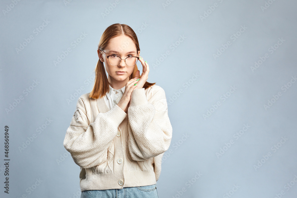 Young funny woman in casual clothes posing isolated over gray background. Young funny woman in casual clothes posing isolated over gray background.