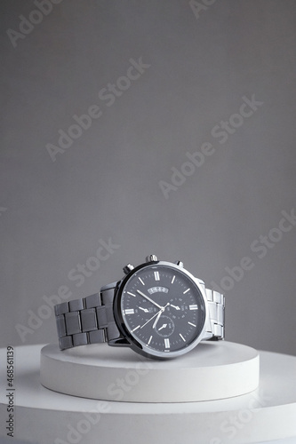 Luxury silver watch on white Table. Business man accessories.