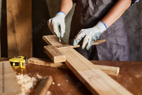 Fotografia, Obraz Woman work to making woodcraft furniture in wood workshop