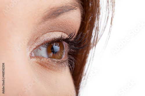 Close up of natural female eye isolated on white background