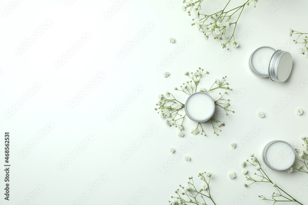Eco lip balm and flowers on white background Eco lip balm and flowers on white background