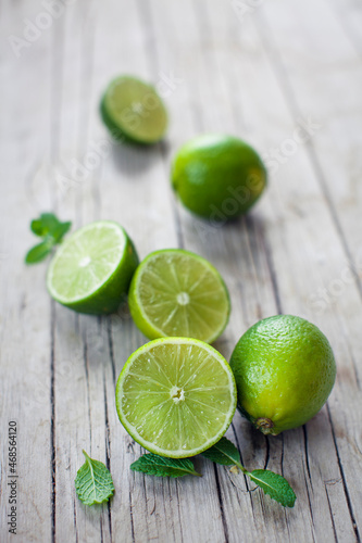 Fresh citrus fruits whole and halved on wooden board