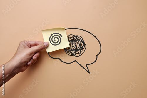 A brain silhouette with a pattern of confusion and a sticker with a pattern of clear lines. Replacing confusion in the head with clear thinking photo