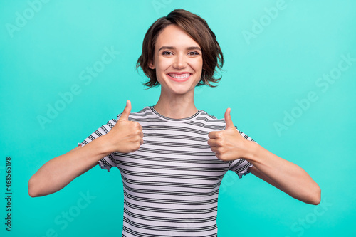 Photo of young girl happy positive smile show thumb-up fine great feedback isolated over teal color background