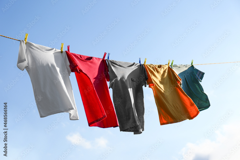 Clothes hanging on washing line against sky Clothes hanging on washing line against sky