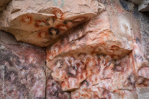 Ancient rock art at the Cave of the Hands (Spanish: Cueva de Las Manos ) in Santa Cruz Province, Patagonia, Argentina. The art in the cave dates from 13,000 to 9,000 years ago. photo