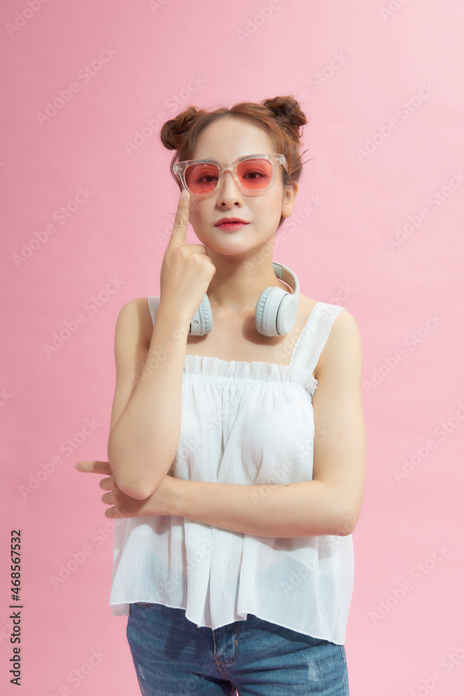 Attractive cheerful girl wearing touching specs posing good mood isolated over pink color background