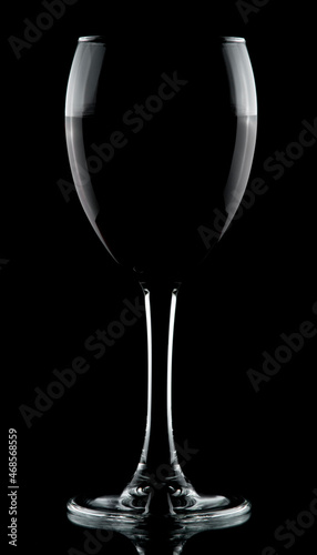 half full wine glass isolated on black background low key rim lighting