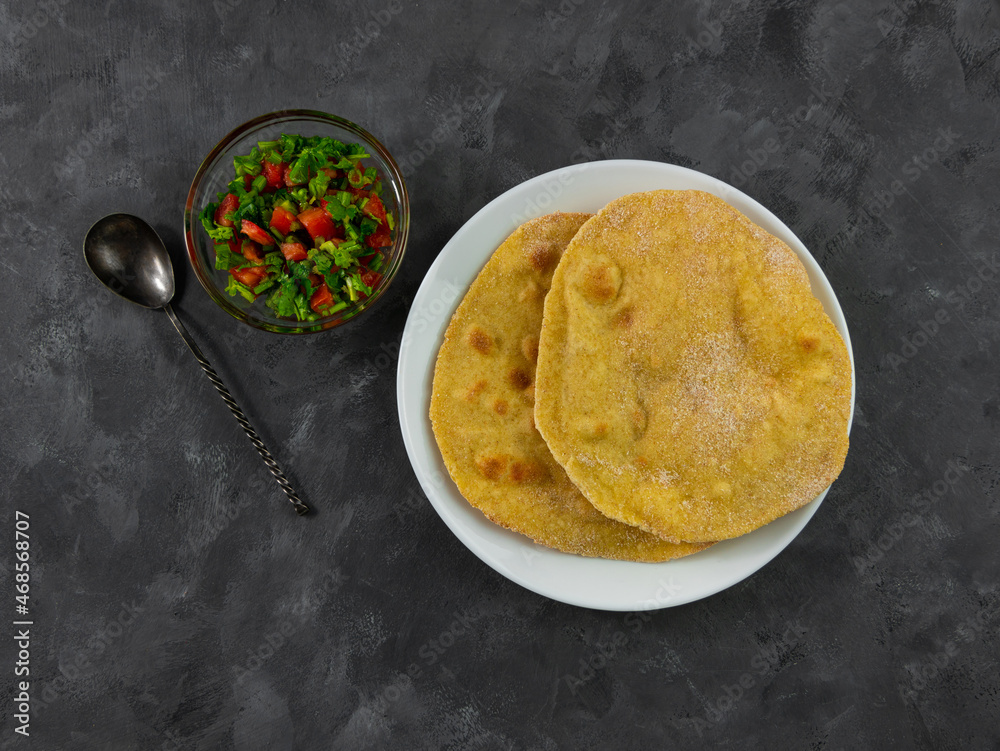 Homemade corn flatbread with cilantro greens tomato salsa. Handmade