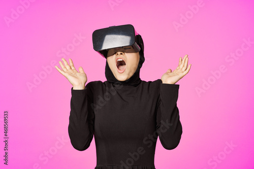 woman in black hijab glasses virtual reality technology movie watching
