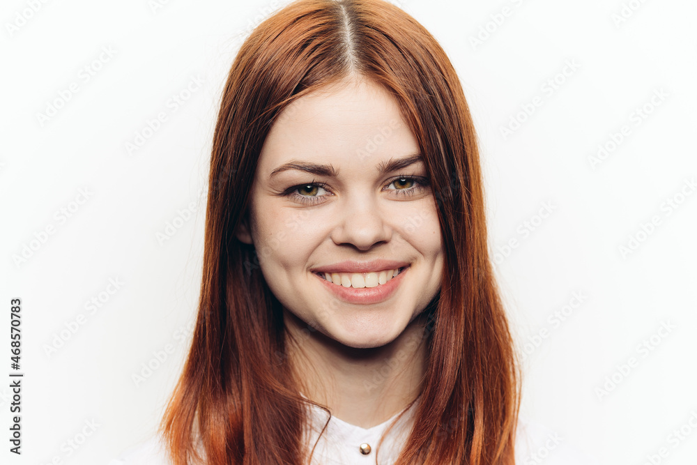 red-haired woman in a white shirt with a magnifying glass in her hands searching red-haired woman in a white shirt with a magnifying glass in her hands searching