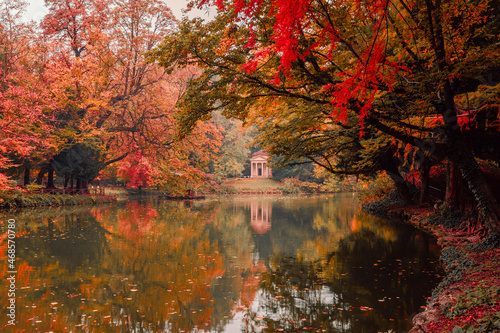 Lake with neoclassical temple  Tempietto del lago dei cigni  in the park of Monza during the autumn foliage