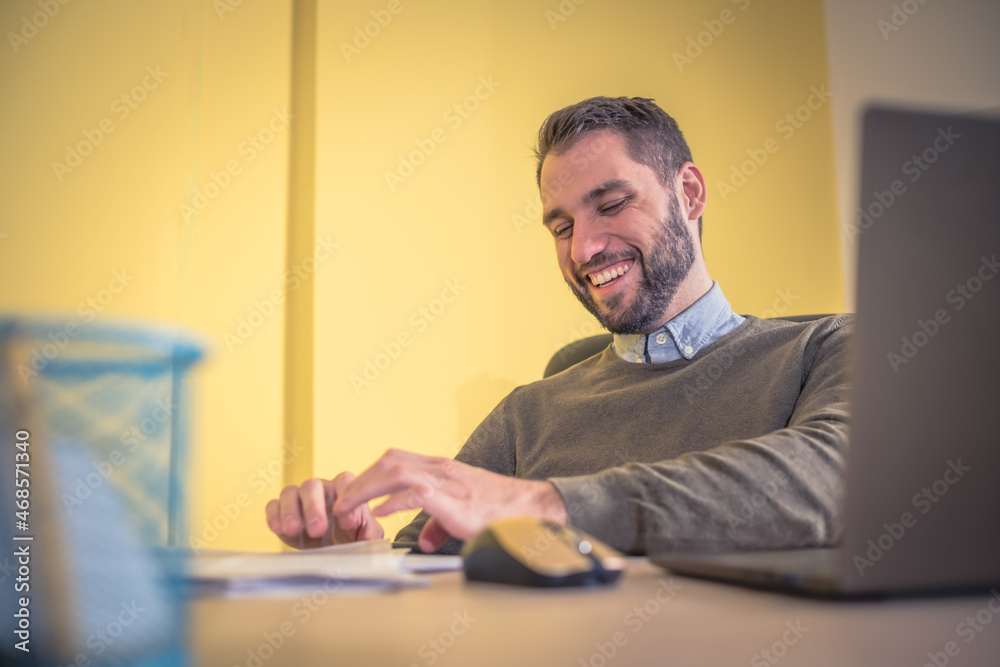 businessman smiling and typing on notebook businessman smiling and typing on notebook