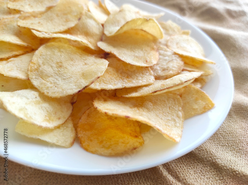 Potato chips or crisps on a white plate.