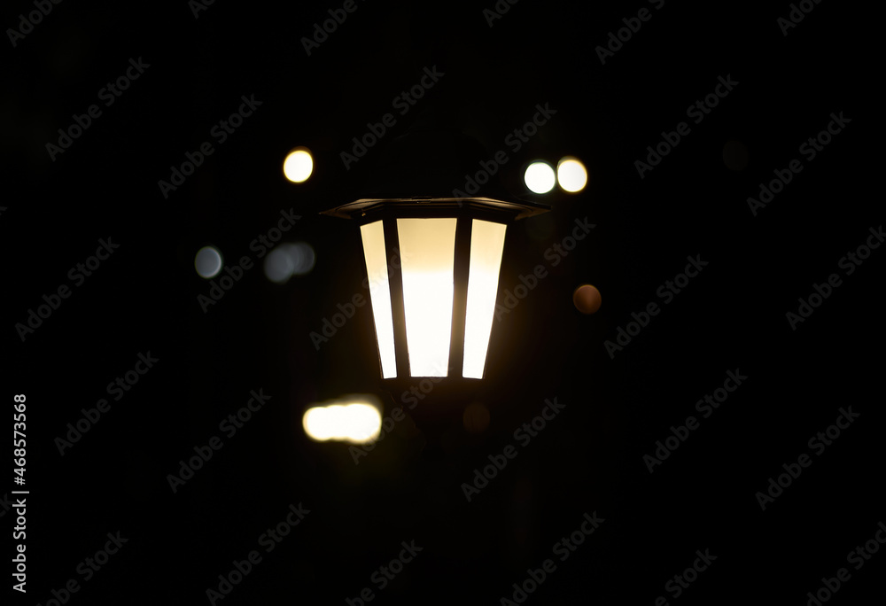 Lantern in the dark. Burning lantern in the dark. Electric lamp.