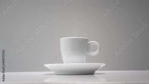 Cup of coffee, white ceramic, grey background 
