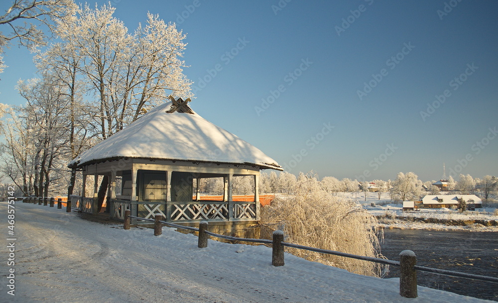 Old, small cafe and frosted trees in winter day, Kuldiga, Latvia. Old, small cafe and frosted trees in winter day, Kuldiga, Latvia.