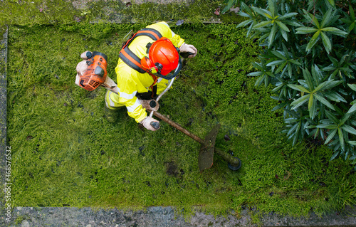 aerial view of a professional gardener mowing a lawn