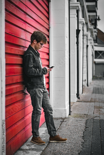 фотографія Male punk leaning on shutters
