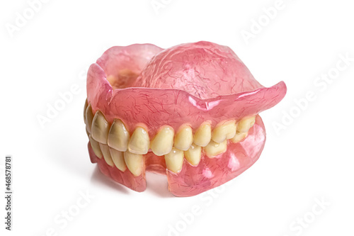 Side view of an acrylic plastic denture with white teeth