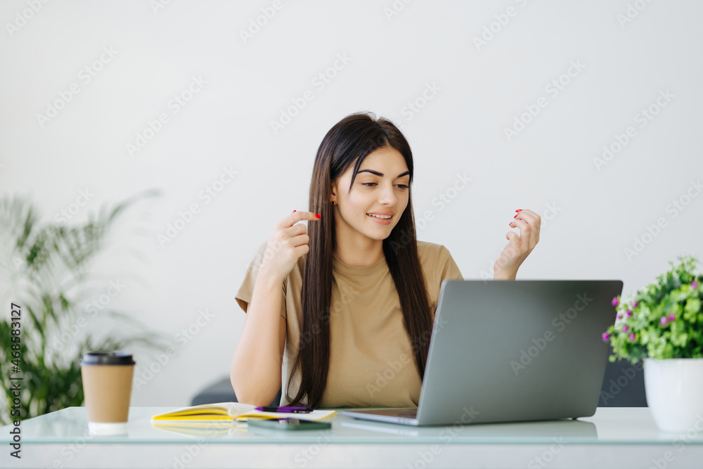Surprised woman looking computer screen indoor. Excited girl chatting on laptop computer. Happy businesswoman closing face in front of notebook in home office. Surprised woman looking computer screen indoor. Excited girl chatting on laptop computer. Happy businesswoman closing face in front of notebook in home office.