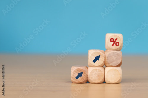 wooden cube block with arrow icon pointing towards percentage symbol icon, Finance and Mortgage Concepts interest rate