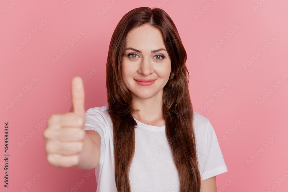 Portrait of charming cheerful girl show thump up look camera promoting on pink background Portrait of charming cheerful girl show thump up look camera promoting on pink background
