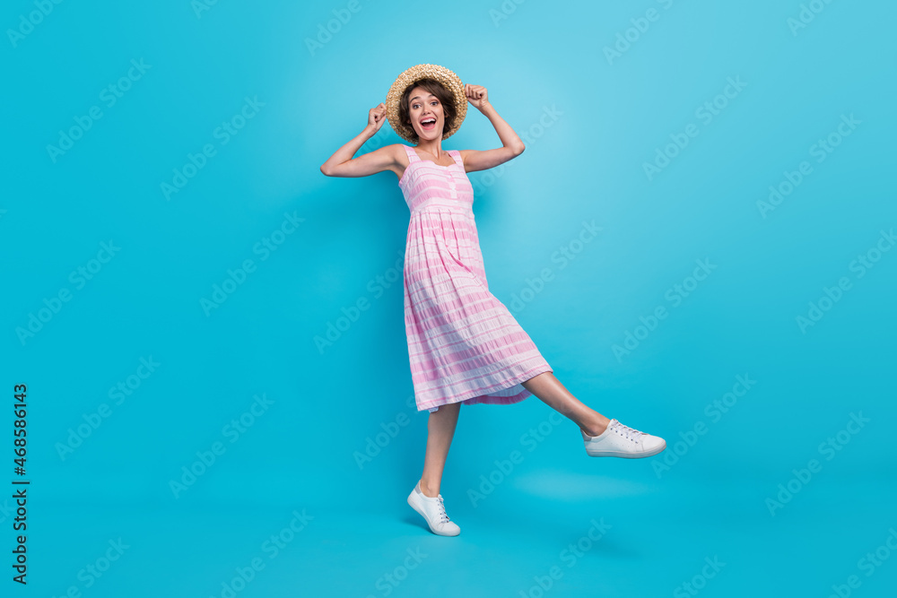 Full length photo of funky young lady go wear hat long sarafan isolated on blue background