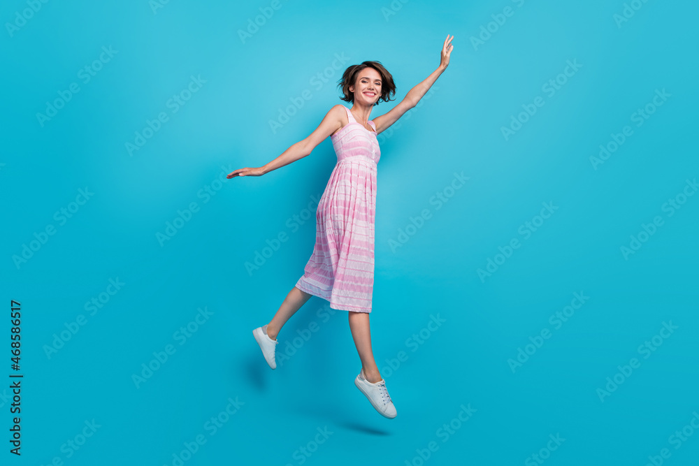 Full size profile photo of carefree young lady run wear pink dress sneakers isolated on blue background