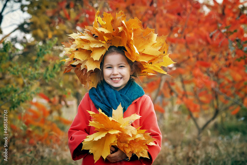 Portrait of a beautiful little girl in a wreath of autumn leaves © fisher05