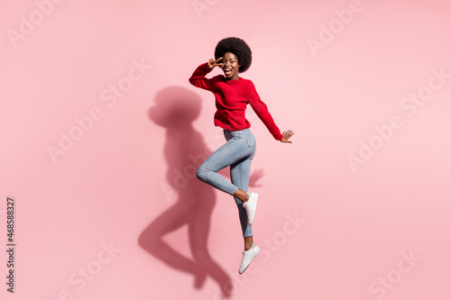Full size profile photo of crazy attractive dark skin lady fingers show v-sign near eye isolated on pink color background