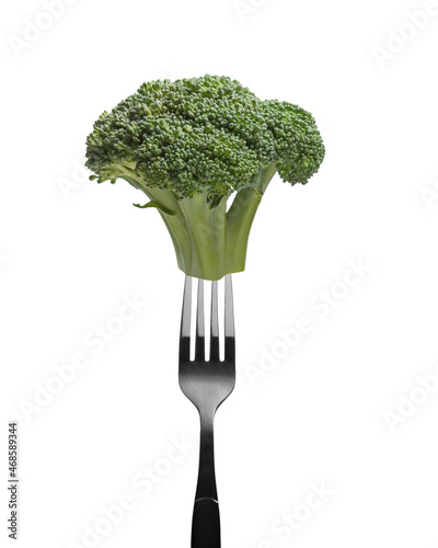 green broccoli on a fork on a white background