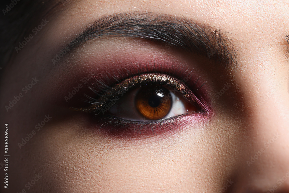Bright pink professional makeup on eyes of woman closeup Bright pink professional makeup on eyes of woman closeup