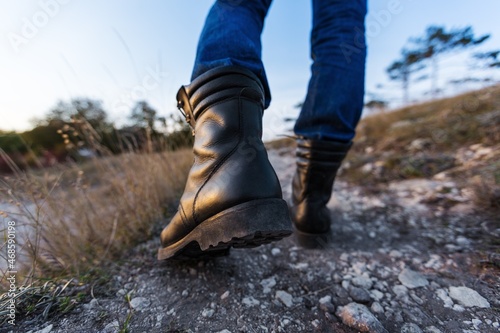 Hiker jumps over the rock