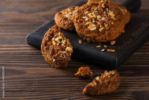 Oatmeal, quinoa and carrot cookies on a wooden board. Sugar, gluten and lactose free and vegan.
