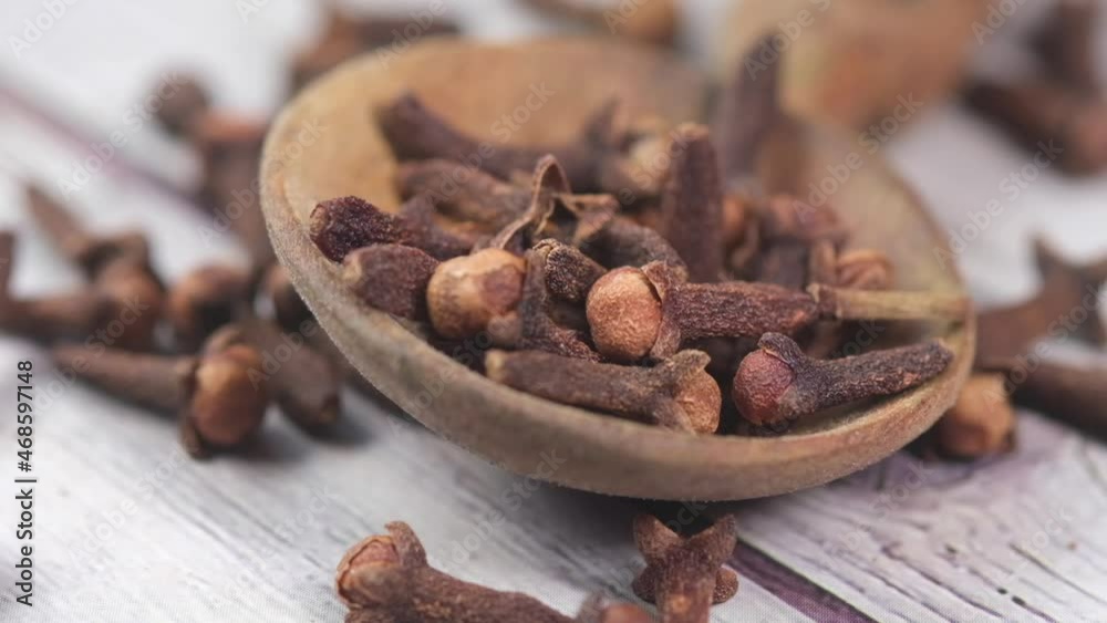 slow motion of dropping cloves on spoon on table close up slow motion of dropping cloves on spoon on table close up