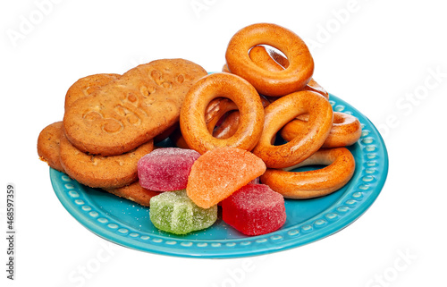 Sweets to tea laid out on a blue plate. Isolated on white background