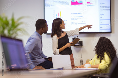 Happy diverse group of business people discussing work in modern office photo