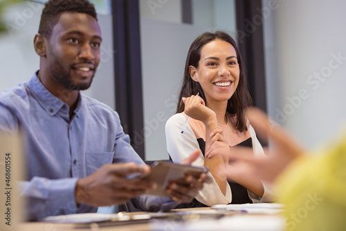 Happy diverse group of business people discussing work in modern office photo