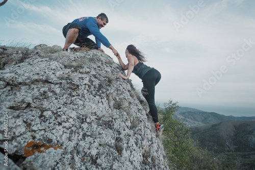 Couple rock climbing together in mount