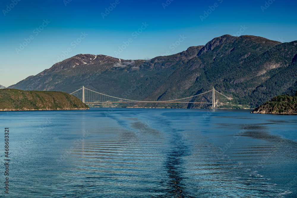 Norway from the seaside with a large suspension bridge on a cloudless day