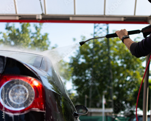 washing car with high pressure water