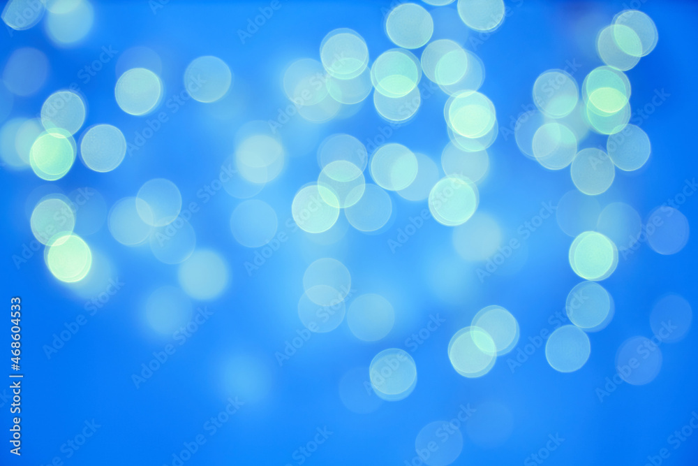 Glowing garland bokeh in blue. Christmas background