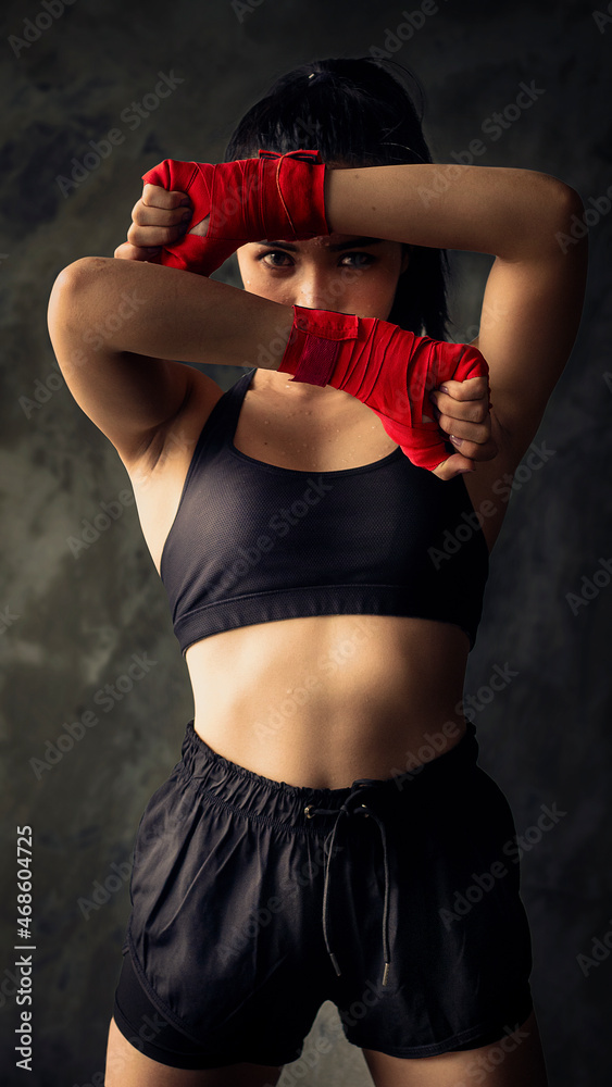 Fototapeta premium Wrapped in red cloth to make it ready to fight. Health care concept with exercise