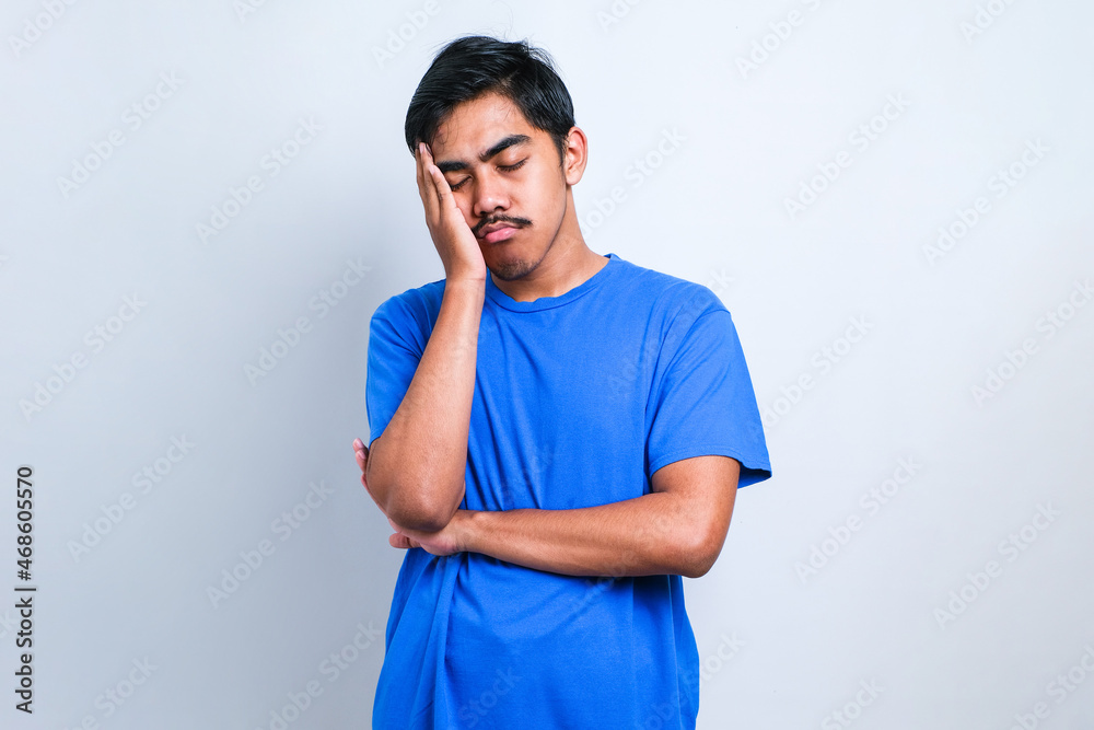 Young asian man wearing casual shirt thinking looking tired and bored Young asian man wearing casual shirt thinking looking tired and bored